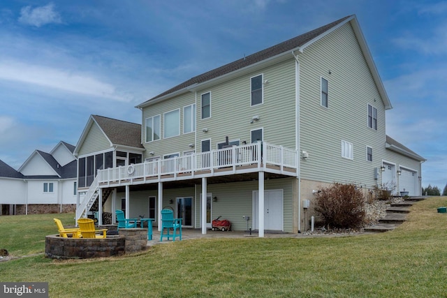 rear view of property featuring a sunroom, a yard, a deck, and a patio area