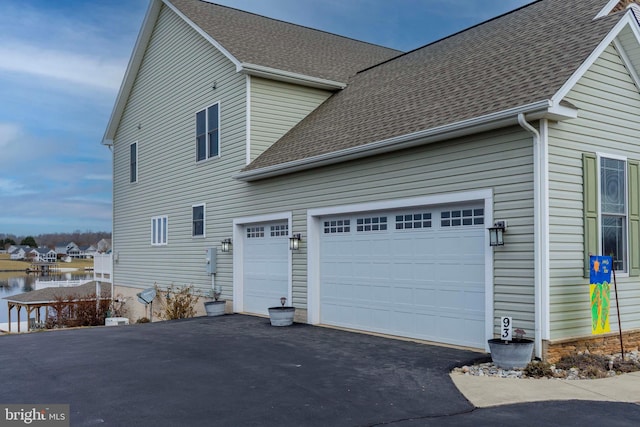 view of side of property with a garage