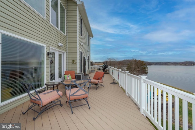 wooden terrace featuring a water view