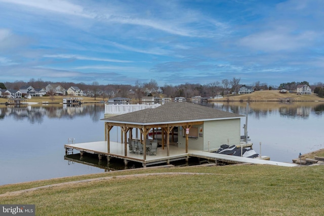 view of dock with a water view and a yard