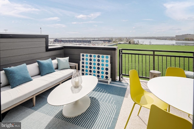 exterior space featuring an outdoor living space, a lawn, and a water view