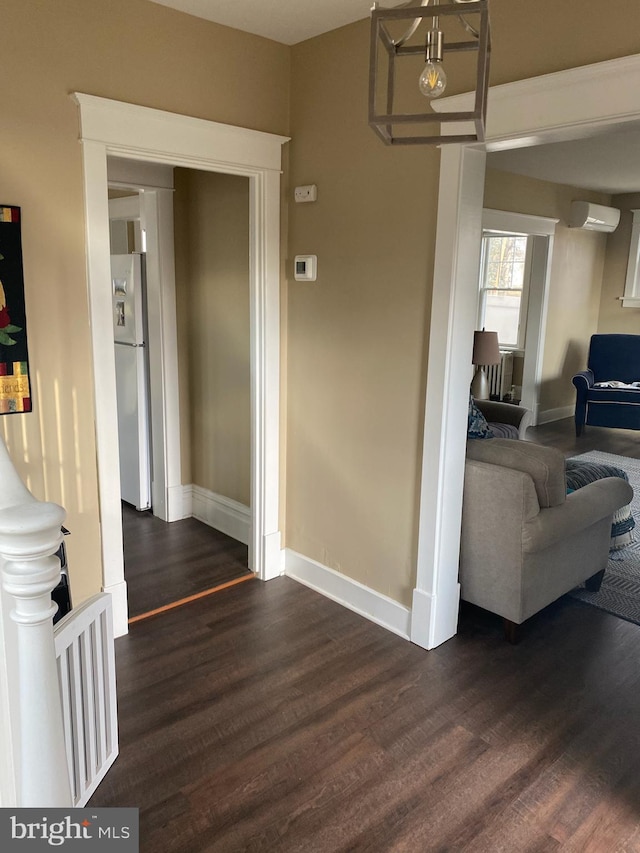 hall featuring dark hardwood / wood-style flooring and a wall mounted air conditioner