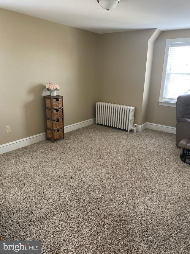 carpeted office space featuring radiator