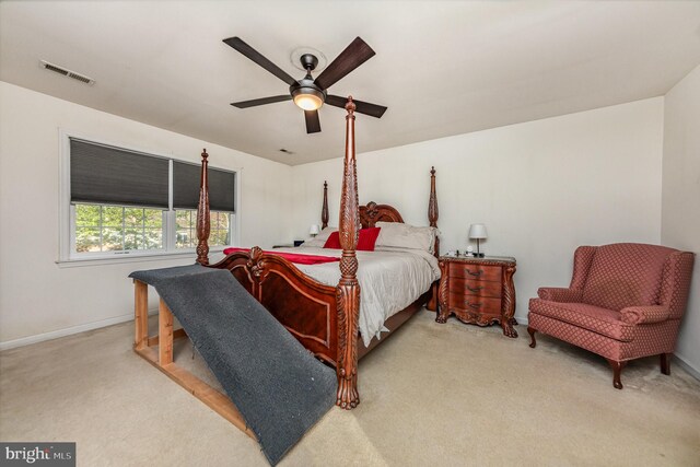 bedroom featuring ceiling fan, baseboards, visible vents, and light carpet