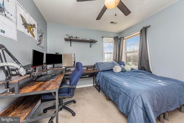 bedroom featuring ceiling fan, visible vents, and light carpet