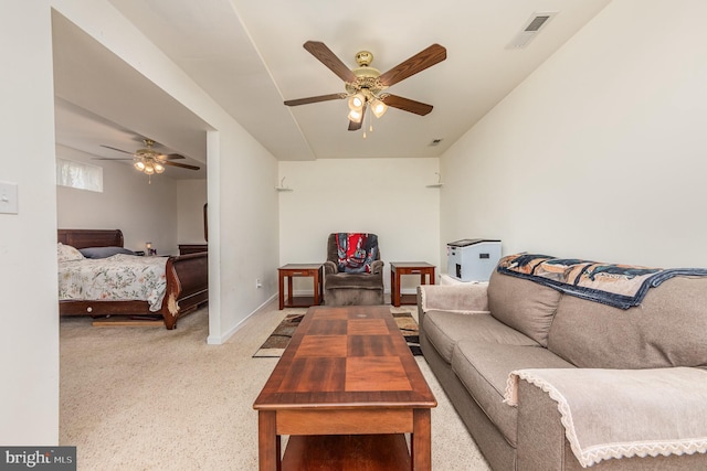 carpeted living area with a ceiling fan, visible vents, and baseboards