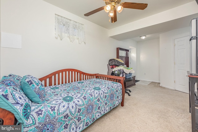 carpeted bedroom featuring a ceiling fan and baseboards