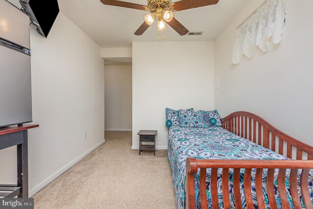 bedroom featuring a ceiling fan, speckled floor, baseboards, and visible vents