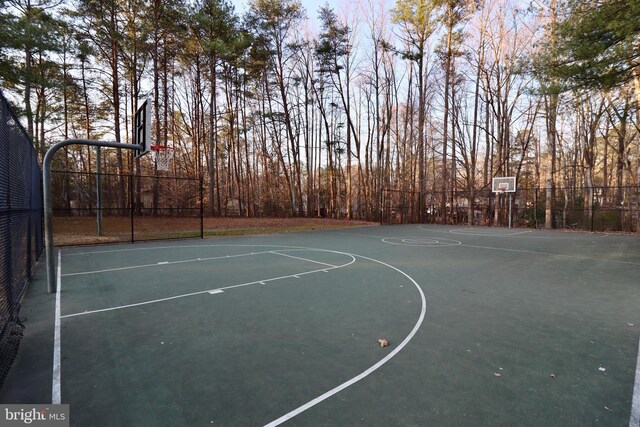 view of basketball court featuring community basketball court and fence