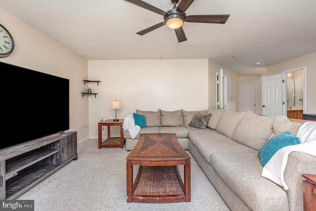 carpeted living room with baseboards and ceiling fan