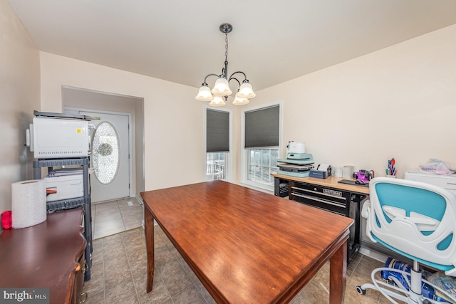 tiled home office featuring a notable chandelier