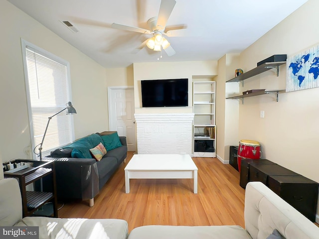 living room with ceiling fan and light hardwood / wood-style floors