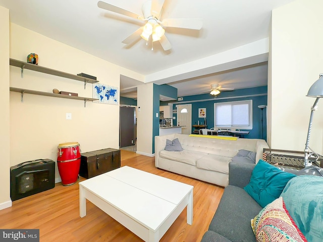 living room featuring light hardwood / wood-style floors and ceiling fan