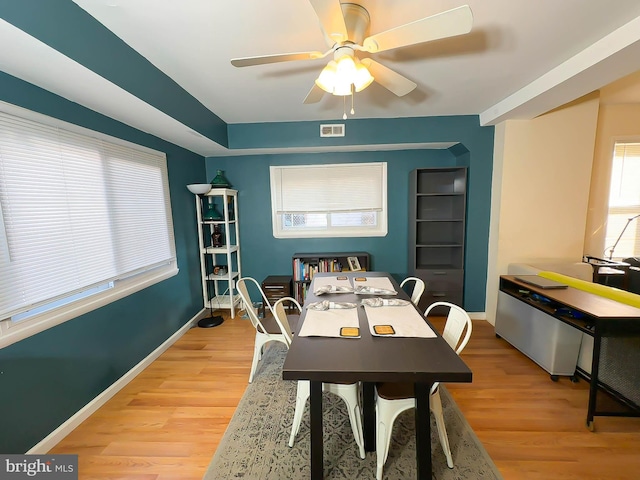 dining space featuring ceiling fan and light wood-type flooring