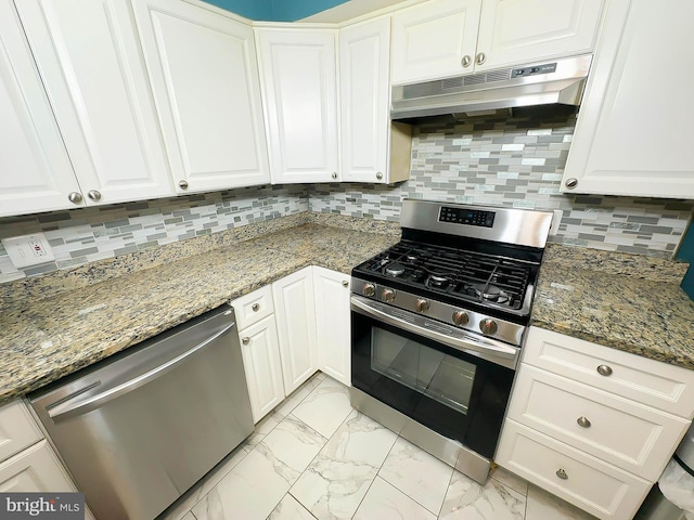 kitchen with tasteful backsplash, white cabinetry, appliances with stainless steel finishes, and stone countertops