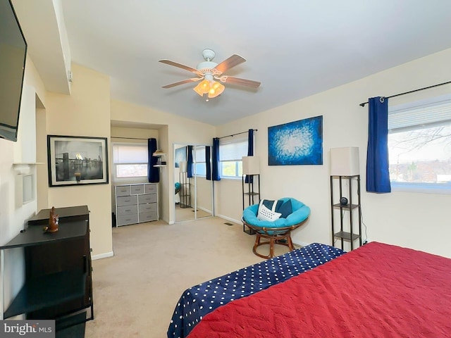 bedroom with ceiling fan, lofted ceiling, and light carpet