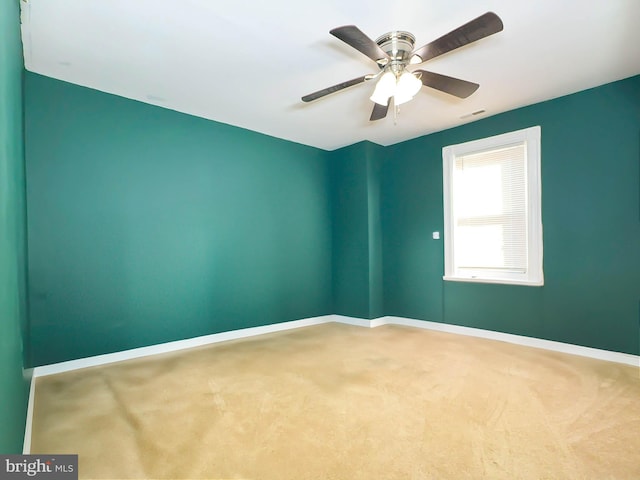 spare room with carpet floors and ceiling fan