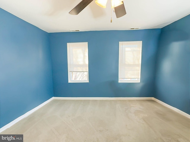 unfurnished room with carpet flooring and ceiling fan