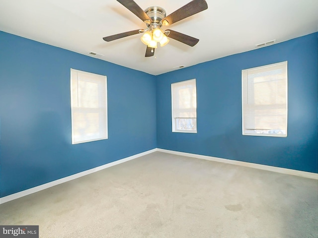 carpeted empty room featuring ceiling fan