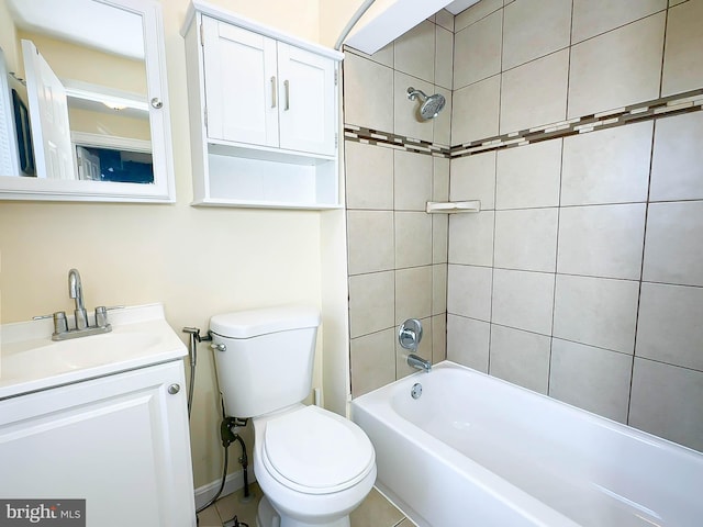 full bathroom featuring vanity, tiled shower / bath combo, and toilet