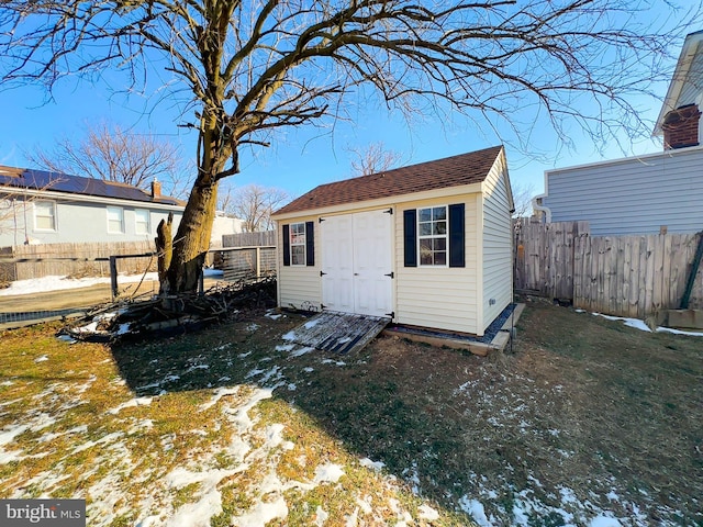 snow covered structure with a yard