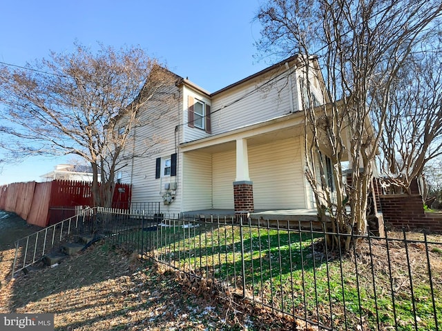 view of home's exterior featuring a lawn and a porch