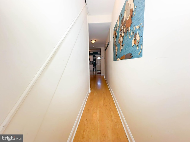 hallway with hardwood / wood-style flooring