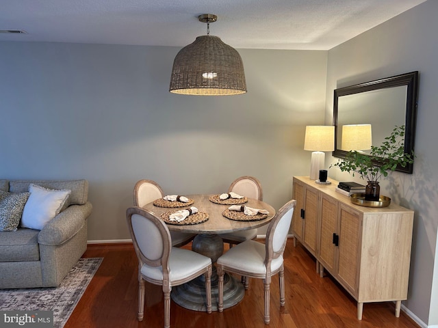 dining space featuring dark hardwood / wood-style flooring