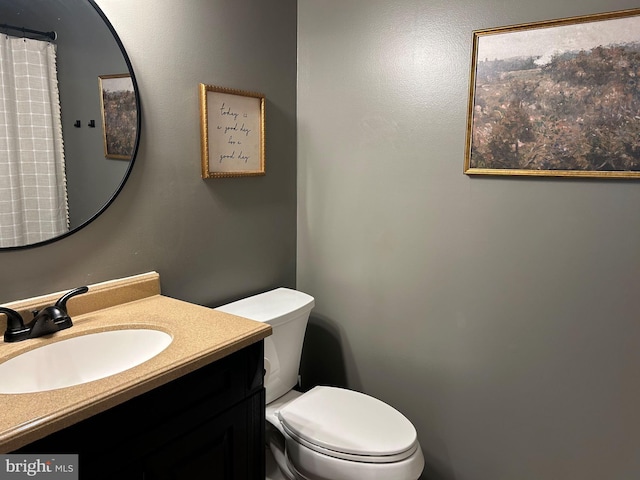 bathroom featuring vanity and toilet