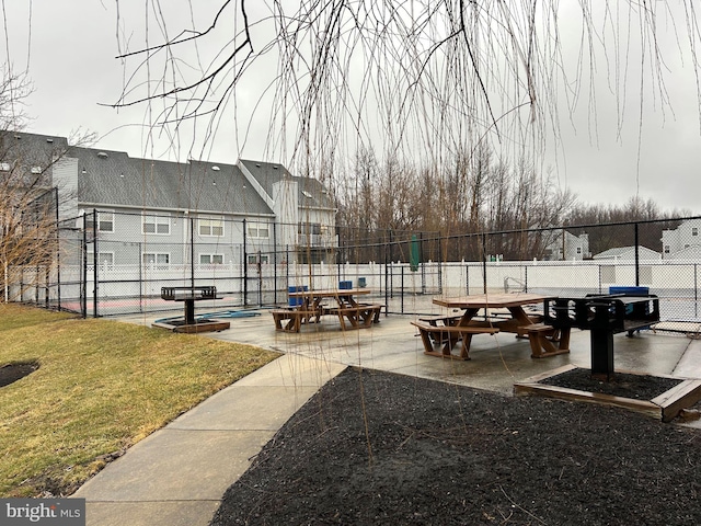 view of community featuring a patio area and a lawn