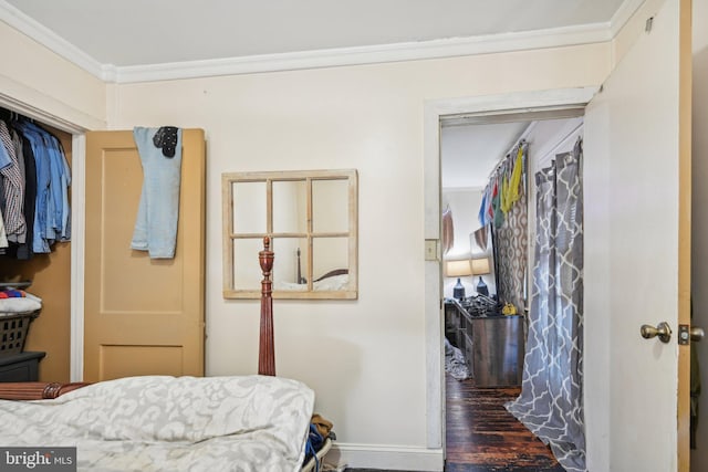 bedroom with crown molding and a closet