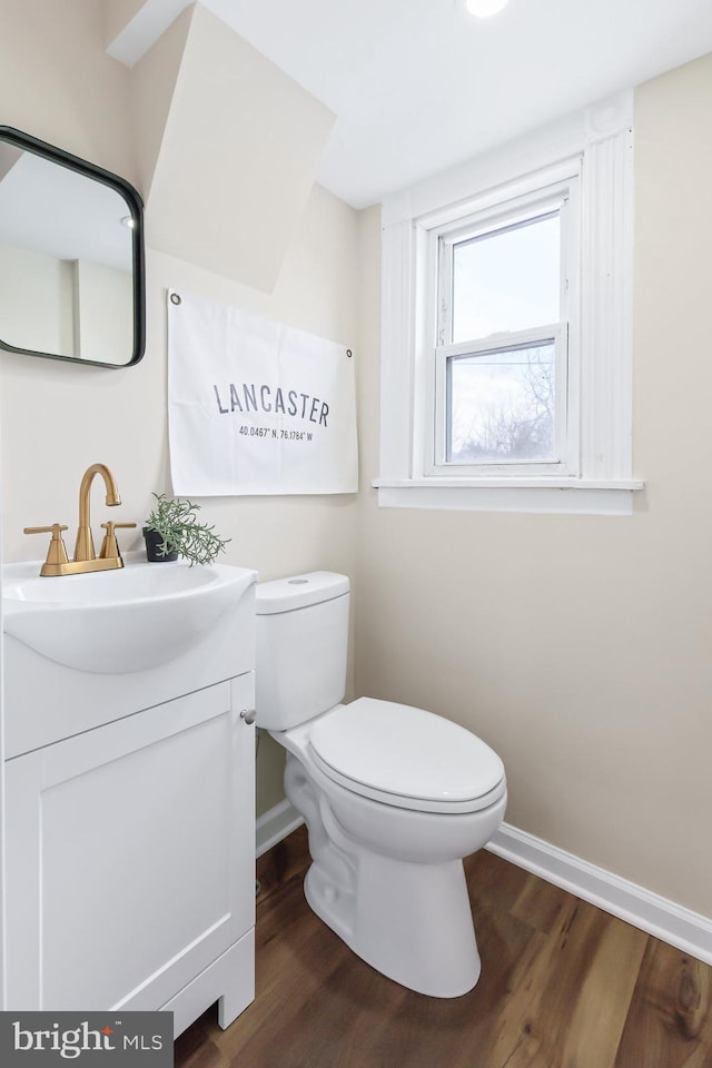 bathroom featuring hardwood / wood-style flooring, vanity, and toilet