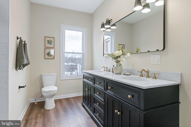 bathroom with hardwood / wood-style flooring, vanity, and toilet