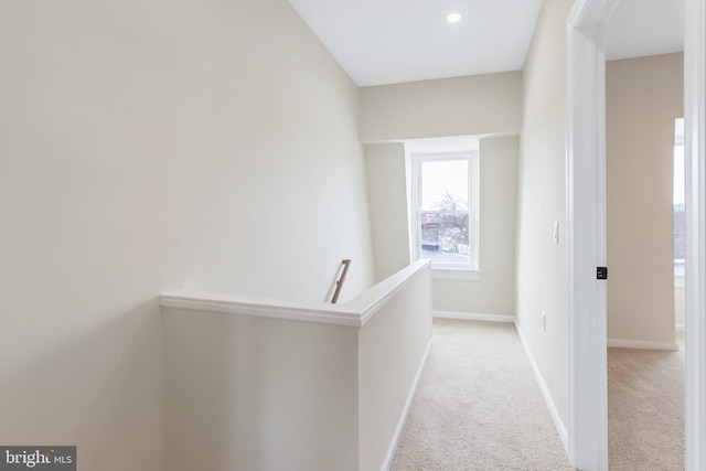 corridor with light colored carpet