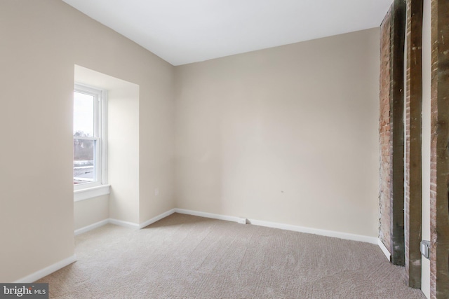 unfurnished room featuring light colored carpet