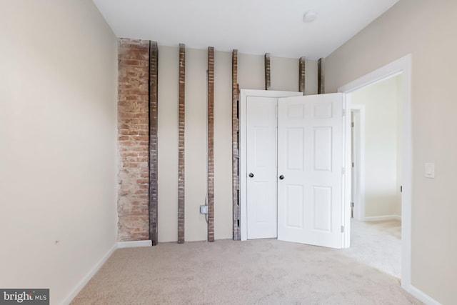 unfurnished bedroom featuring light colored carpet