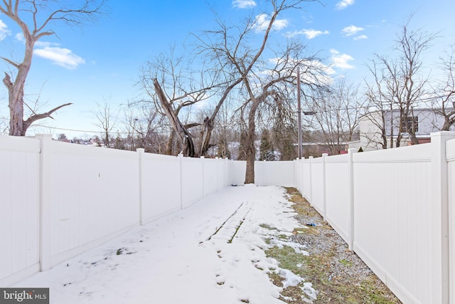 view of yard layered in snow