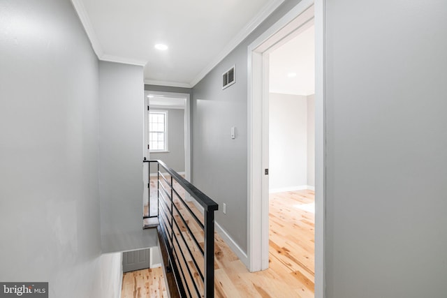 staircase with hardwood / wood-style flooring and crown molding