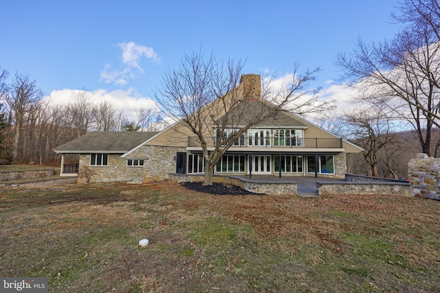 back of property featuring a lawn and a patio area