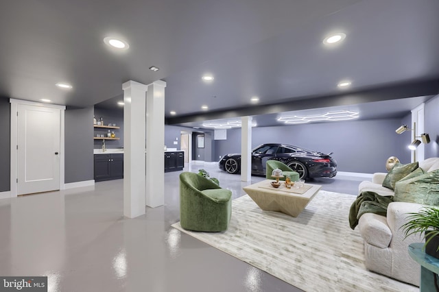 living room with indoor bar and decorative columns