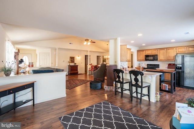 living room with vaulted ceiling, dark wood-type flooring, and ceiling fan