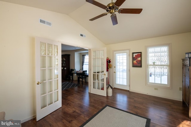 interior space with vaulted ceiling, dark wood-type flooring, and french doors