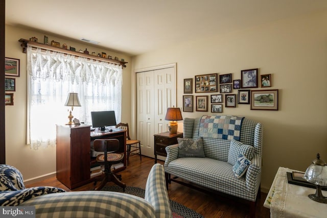 home office with dark hardwood / wood-style flooring