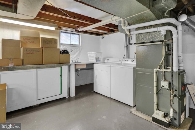 basement featuring sink and washer and dryer