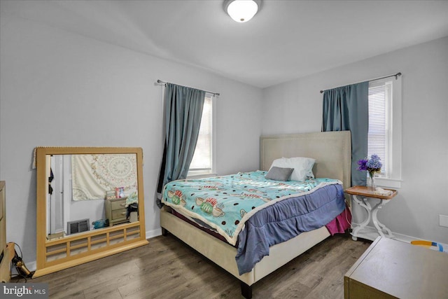 bedroom with dark wood-type flooring