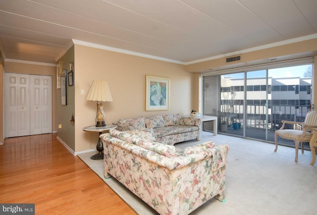 living room with hardwood / wood-style flooring and ornamental molding