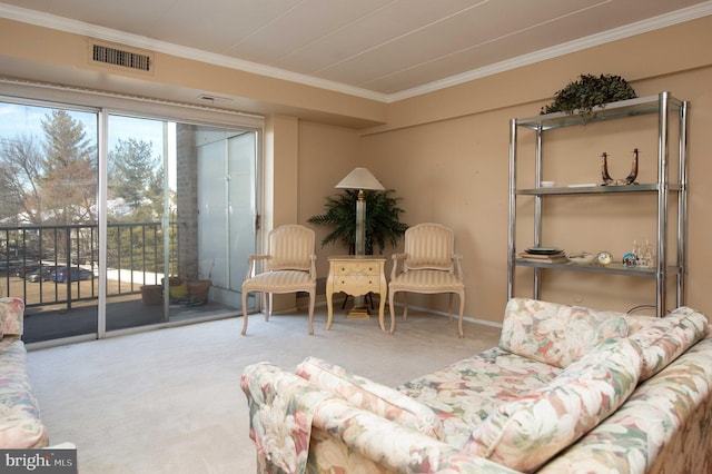 living area featuring crown molding and carpet