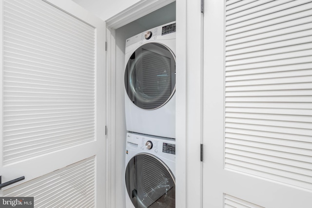 laundry room with stacked washer and dryer