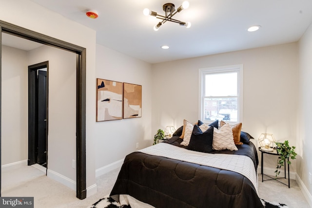 carpeted bedroom with an inviting chandelier