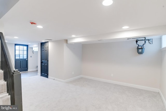 basement featuring light colored carpet